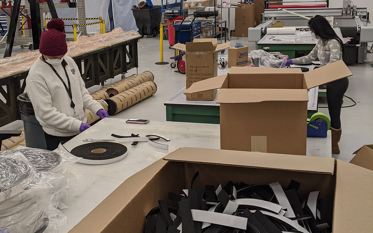 Wisk volunteers work on face shields for medical workers