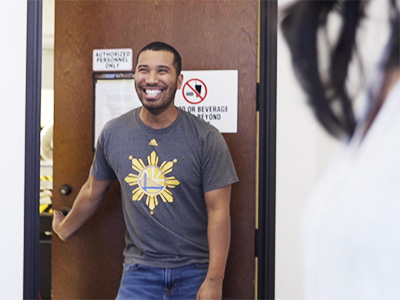 happy employee opening door