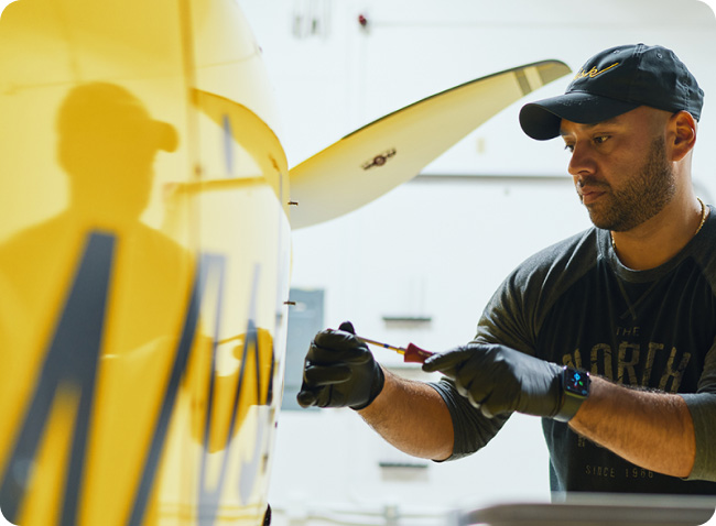 Person working on an exterior panel of the aircraft